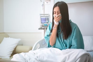 young woman patient sit on bed in hospital