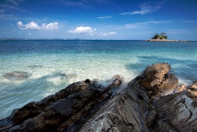 hidden beauty nature of kapas island located in malaysia, magical rock formation over blue sky background. selective focus image at sunny day