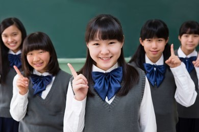 female students of japanese to make a finger