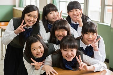 female students of japanese to peace sign