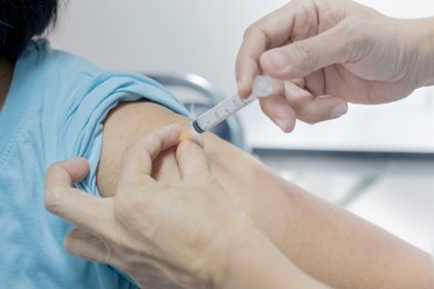 influenza vaccine injection , nurse inject drug solution in deltoid