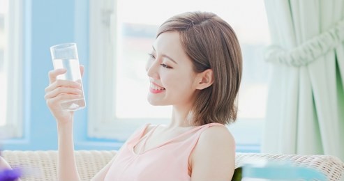 woman drink water and feel happily at home