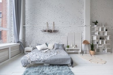 spacious stylish loft apartment in white and light colors. large room with nobody full of sun light