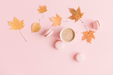 autumn  elegant composition. cup of coffee and dry leaves on pastel pink background. flat lay, top view, copy space