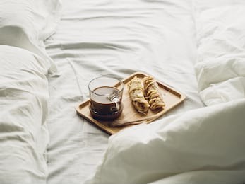 breakfast set of thai sweetened roti and hot cocoa served on bed.