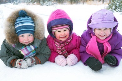 group of children playing on snow in winter time