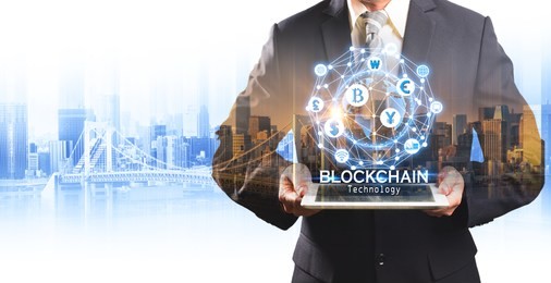 businessman hold the blockchain hologram on tablet, business and technology, internet of thinks and network the concept of cryptocurrency, blockchain 

