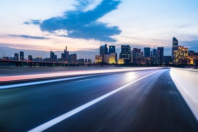empty asphalt road with pnoramic city skyline