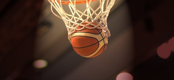 the orange basketball ball flies through the basket