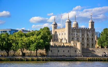 view of the tower of london, a castle and a former prison in london, england, from the river thames. the tower of london, today a museum, is a fortified complex that includes multiple buildings