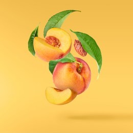 flying fresh ripe peach with green leaves isolated on yellow background. concept of food levitation, high resolution image