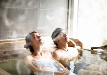 young couple relaxing in hot springs 