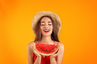beautiful young woman posing with watermelon on color background