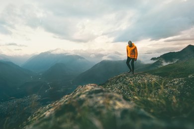 man traveler hiking in mountains  adventure solo traveling lifestyle concept active weekend vacations wild nature