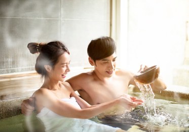 young couple relaxing in hot springs 