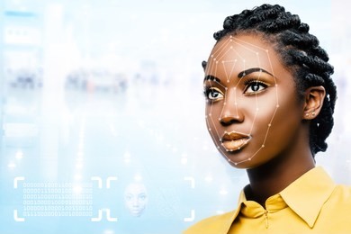 close up portrait of attractive young african woman showing conceptual face recognition safety scan.