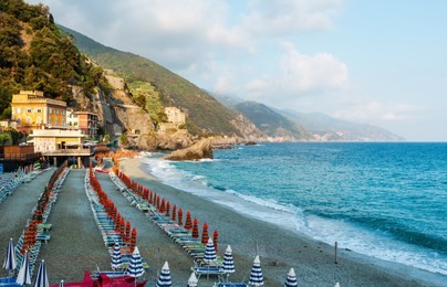 beautiful summer monterosso village beach view. one of five famous villages of cinque terre national park in liguria, italy, suspended between ligurian sea and land on sheer cliffs.