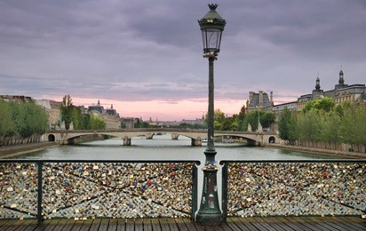 love padlocks on the bridge pont des arts across river seine in paris, france.