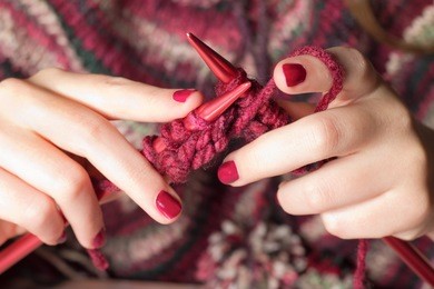 close-up of hands knitting