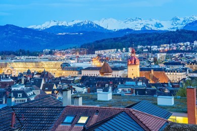 aerial view of the red tiled roofs of the old town of lucerne city, wooden chapel bridge, reuss river and lake lucerne from city wall, switzerland