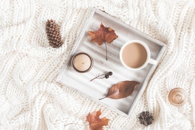 autumn composition. cup of coffee, blanket, dried autumn leaves on white background. flat lay, top view
