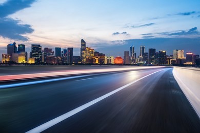 city skyline with empty asphalt road