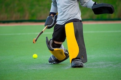 field hockey goalkeeper on a green grass