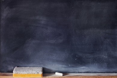 blank blackboard with white chalk and eraser