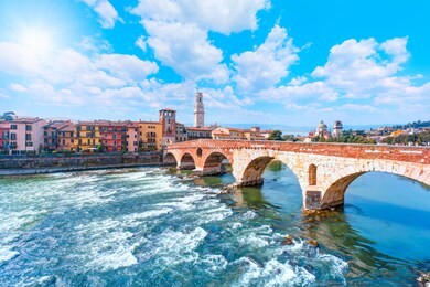 ancient roman bridge ponte pietra and the river adige - verona, italy