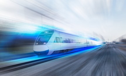 white high speed train runs on rail tracks . train in motion.