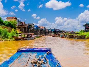 exotic kampong phluk floating village with stilt houses and multicolored boats, tonle sap lake, siem reap province, cambodia

