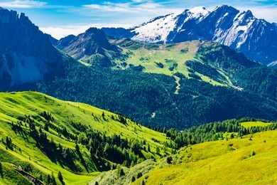 view of the italian alps mountain the dolomites with the snow the small village and the green hill in south tyrol, italy