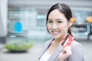 asian young  businesswoman using face recognition login credit card