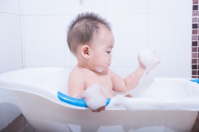 little toddler baby child boy shower taking in bath with bubbles foam