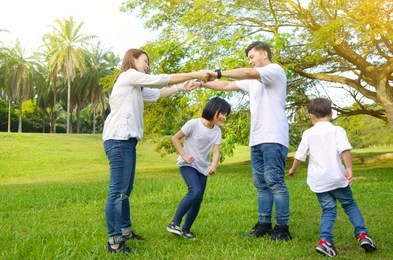 asian family having fun in the park