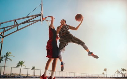 streetball. basketball player in action on sunset. basketball players play in streetbol.