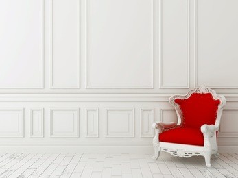 red classic armchair against a white wall and white floor