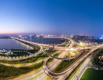 shanghai interchange overpass and elevated road in nightfall， skyline and traffic,flyover in modern city. 