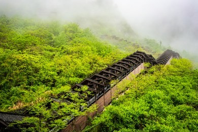 escalator on mountain side at enshi mufu grand canyon scenic area and misty mountains in hubei china