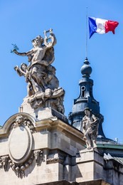 french flag waving on top of the grand palais (grand palais des champs-elysees) in paris, france