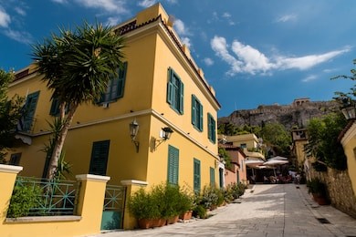 a small alley at anafiotika in plaka under the acropolis of athens on a beautiful day