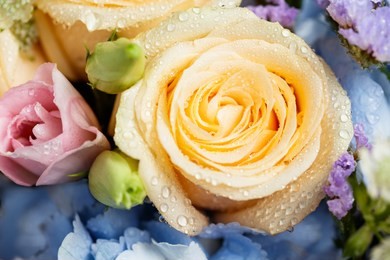 close up of beautiful soft colour flower bouquet with blue hydrangea, peach roses, pink lisianthus, ping pong mums and astrantia.