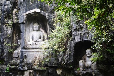 rock reliefs or rock carving at feilai feng or feilai grottoes in lingyin temple, hangzhou, zhejiang, china. the temple's name is translated as temple of the soul's retreat. 