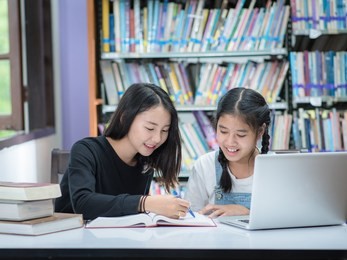 teacher and student asia.teacher and girl at laptop