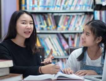 teacher and student asia.teacher and girl at laptop