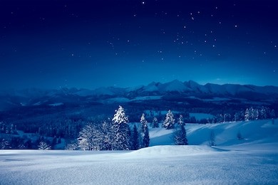snowy winter night. stunning night landscape. sky with stars over snowy mountains and valley.