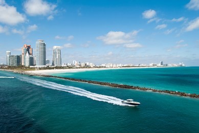 the boat leaving south pointe beach, the popular resort area in miami beach (florida).