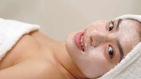 girl gets facial mask at the beauty salon