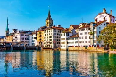 scenic summer view of the old town pier architecture and limmat river embankment in zurich, swizerland