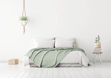 home bedroom interior mockup with bed, green plaid, pillows and plants on empty white wall background. 3d rendering.